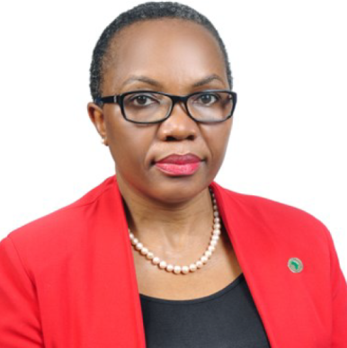 Woman with short hair wearing a red blazer, looks into the camera