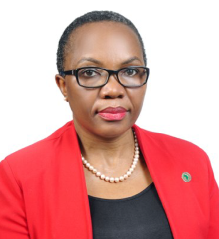 Woman with short hair wearing a red blazer, looks into the camera