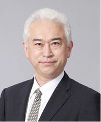 Japanese man with white hair, wearing a black suit, looks into the camera