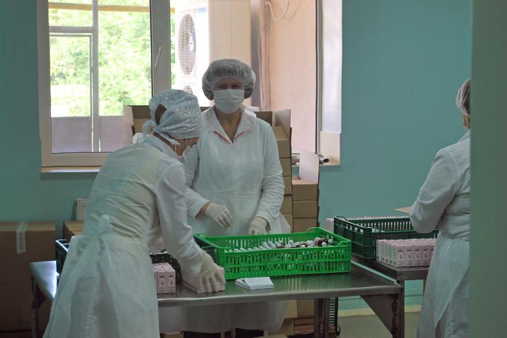 Moldova project photo Private company employees pack pharmaceuticals.