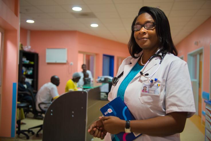 Chad, female doctor African woman in white shirt, wears glasses and a stethoscope around her neck
