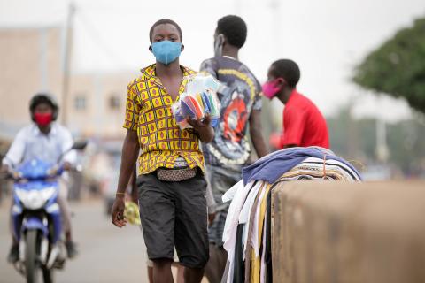A street vendor waving protective masks to traffic users in the Djidjolé neighborhood in Lomé, Togo, Friday, May 15, 2020. The Togolese government declared a state of health emergency on 1 April 2020 to limit the spread of COVID-19 in the country.