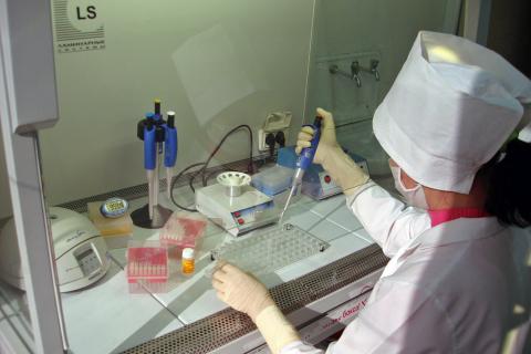 Laboratory specialist working on avian influenza at a renovated human health lab.