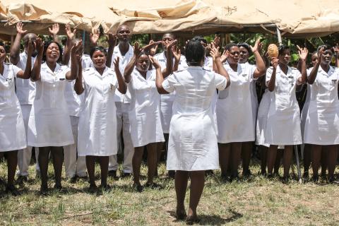 Nursing staff from Zimbabwe, with their arms up in the area in a celebratory fashion